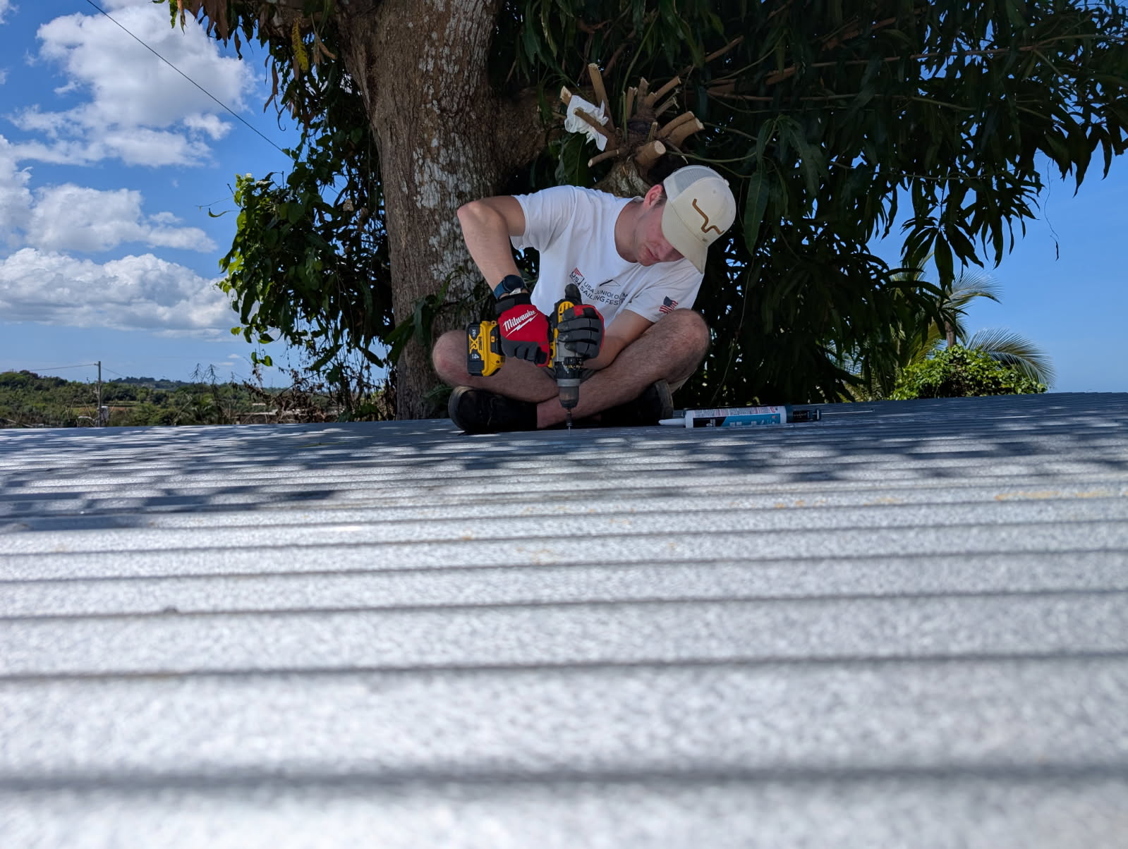 791858185361370123 Elijah Dekker worked hard to get the metal flashing up onto the roof of the chicken coop.