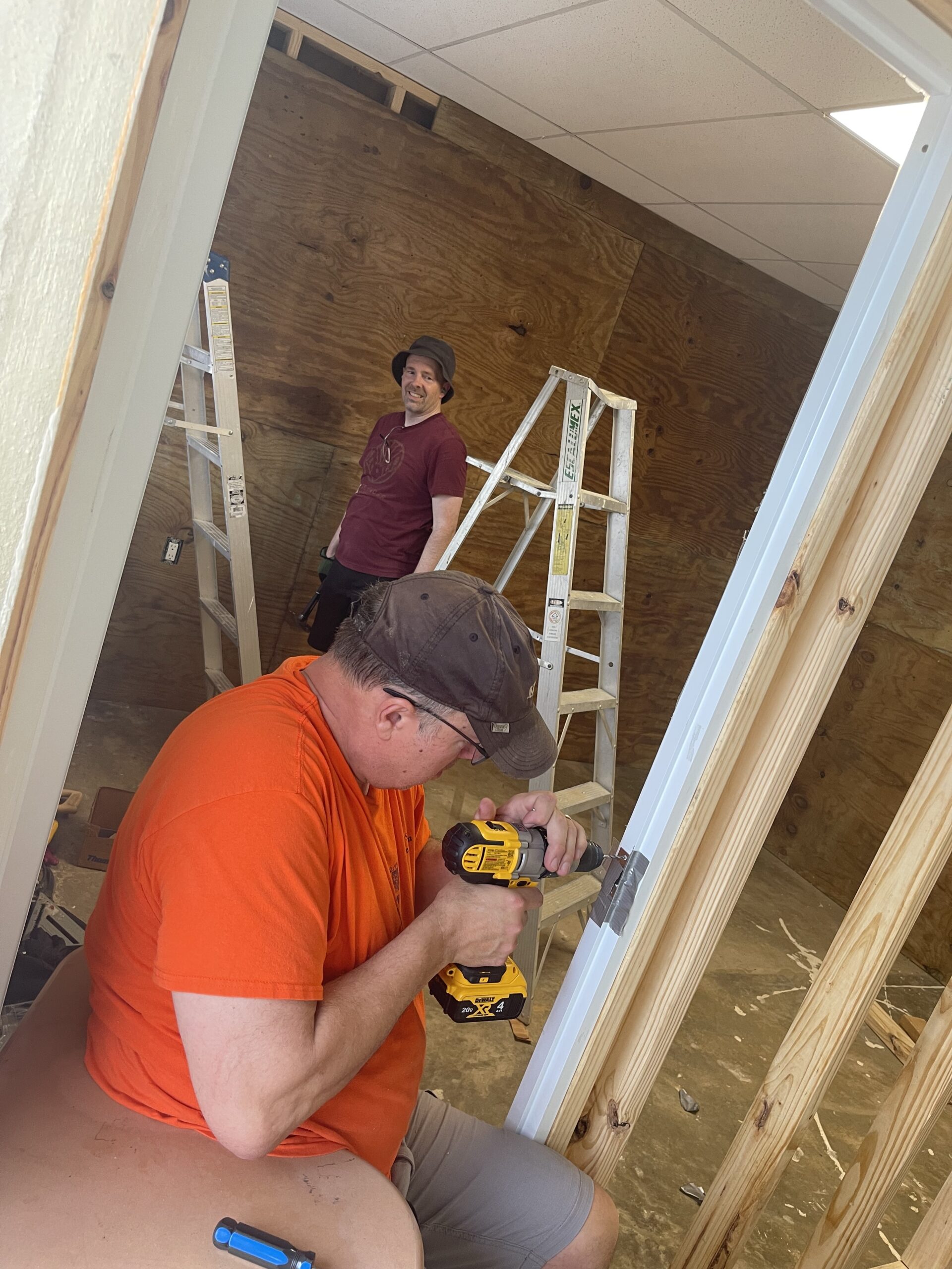 IMG_6113 Zach Layman and John Doornink kept smiles on their faces while pushing through to finish the door frames in the new rooms.
