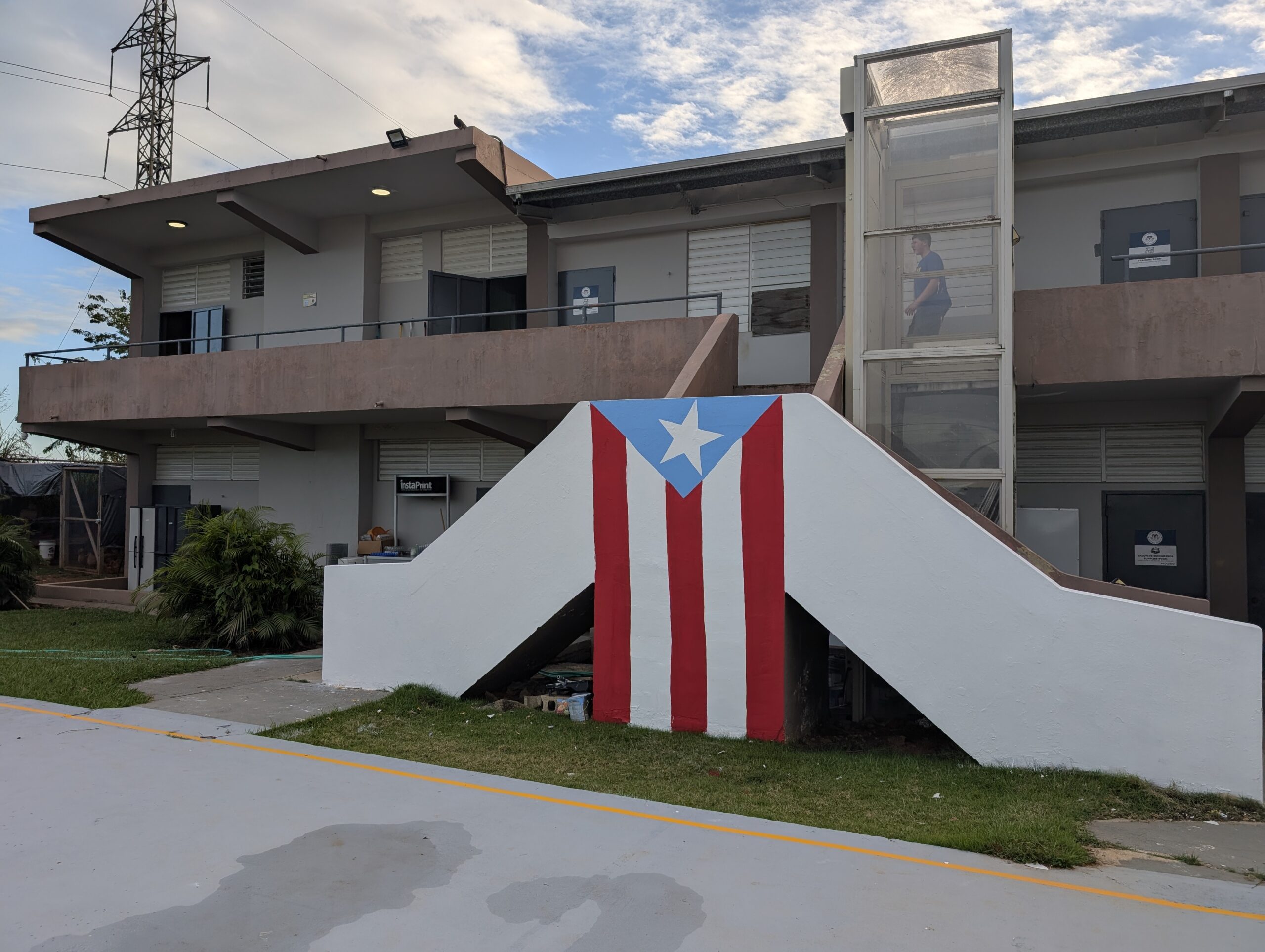 PXL_20250325_220032749 The Puerto Rican flag is a popular sight on buildings and signs. This is the front of the main Somos Gente building.