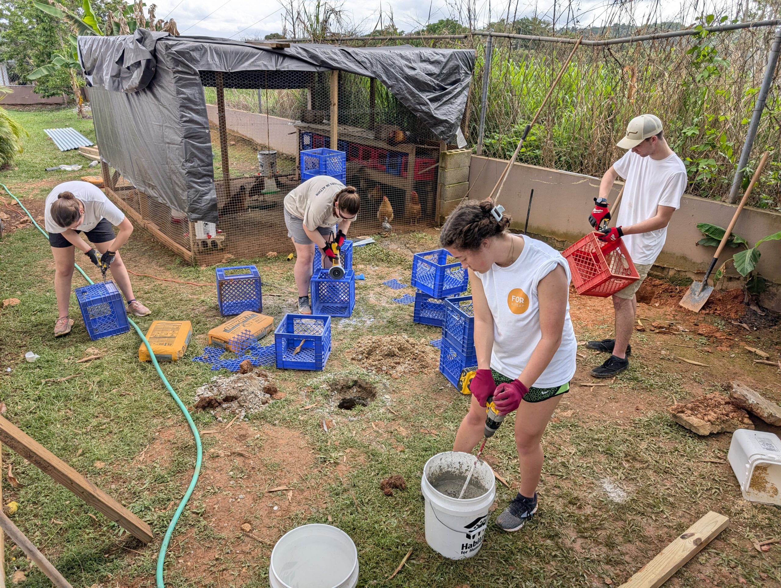 PXL_20250326_143624090 3 Elijah Dekker, Marlee Jernigan, Leah Morse & Addy Leaf worked hard mixing concrete and cutting out milk crates to be used as chicken beds.